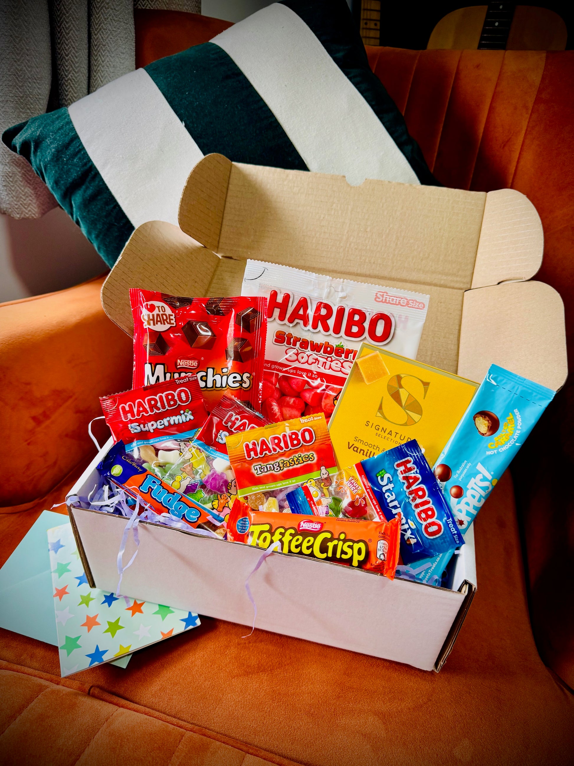 A selection of sweets and chocolates and fudges in a gift box with a handwritten card £10