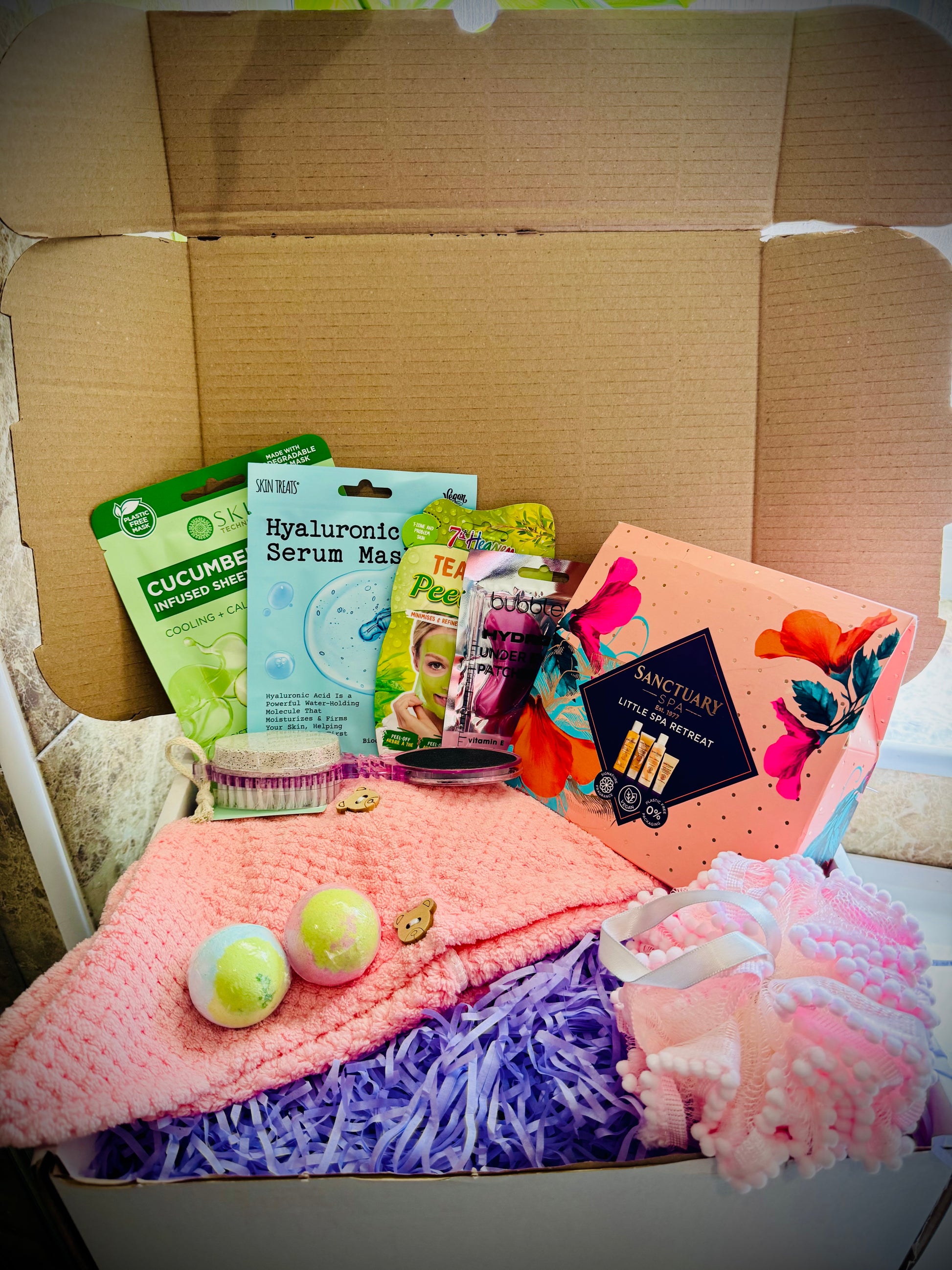 bath and shower gift set with skin care products and beauty tools in a gift box with a handwritten card £50