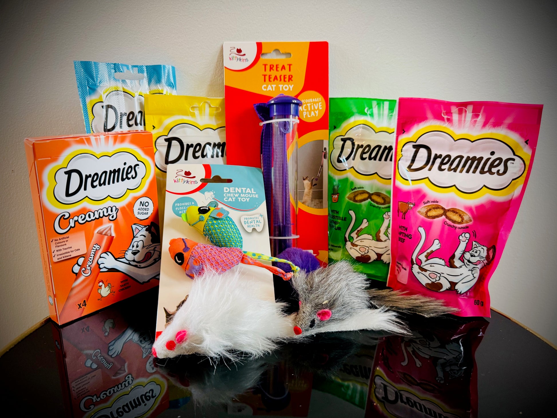 Assorted cat treats and toys with Dreamies packaging in a gift box with a handwritten card £20
