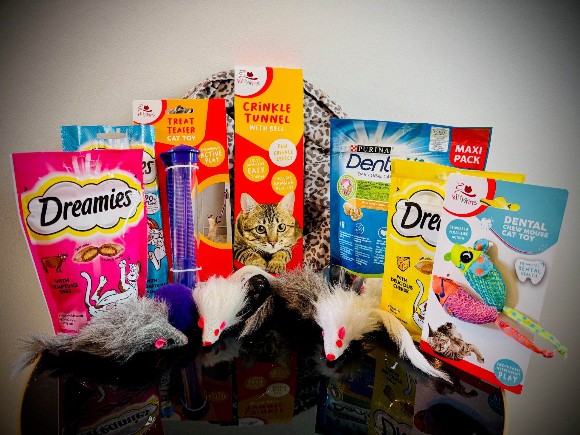 Assorted cat treats and toys with Dreamies packaging in a gift box with a handwritten card £30