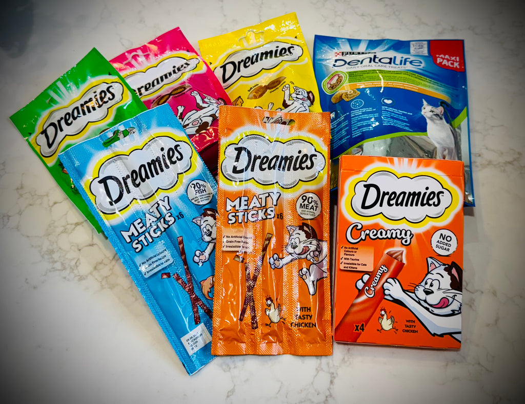 Assorted cat treats and toys with Dreamies packaging in a gift box with a handwritten card £50