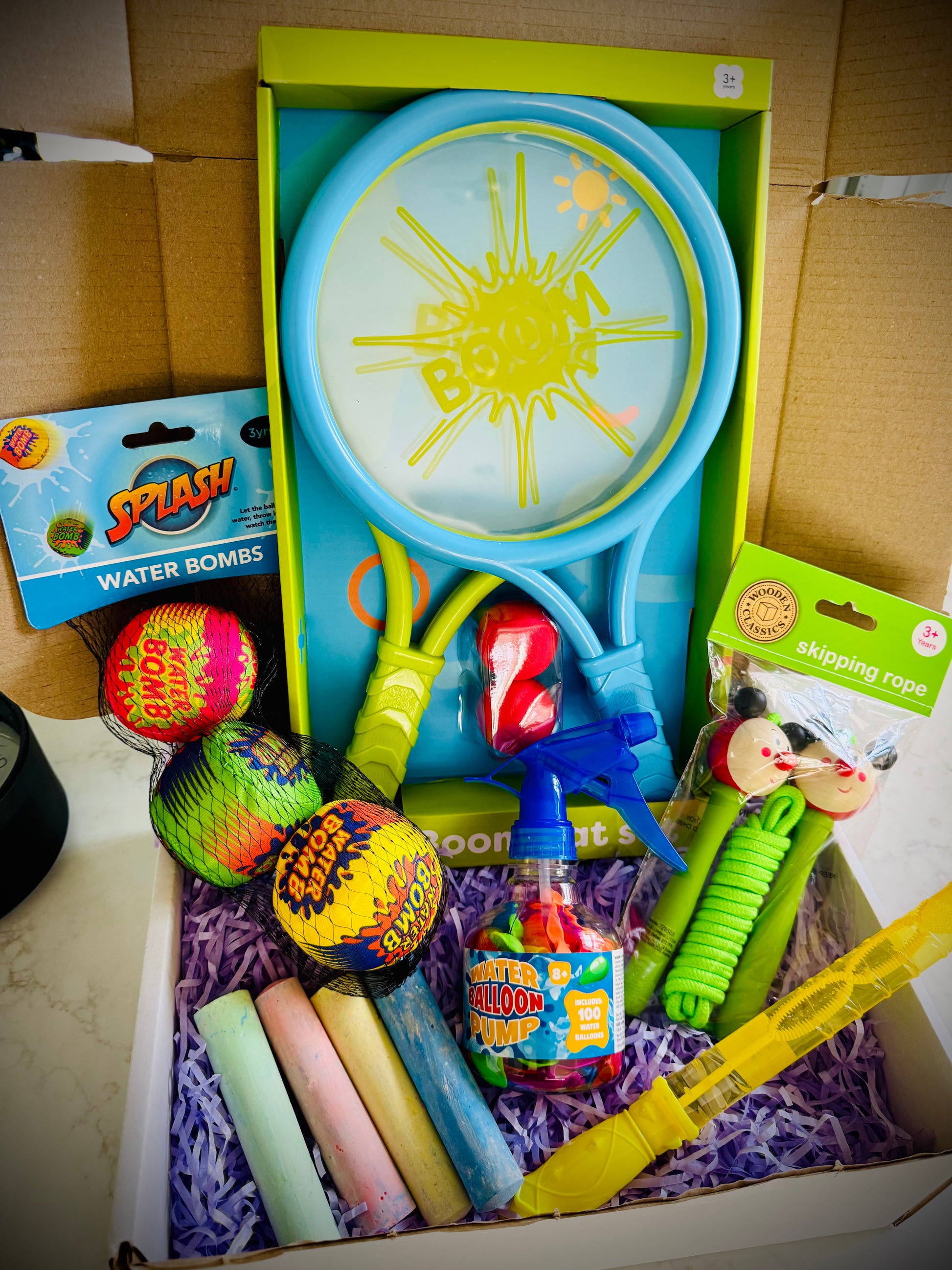 Kids outdoor toys in a birthday gift box with a handwritten card £20