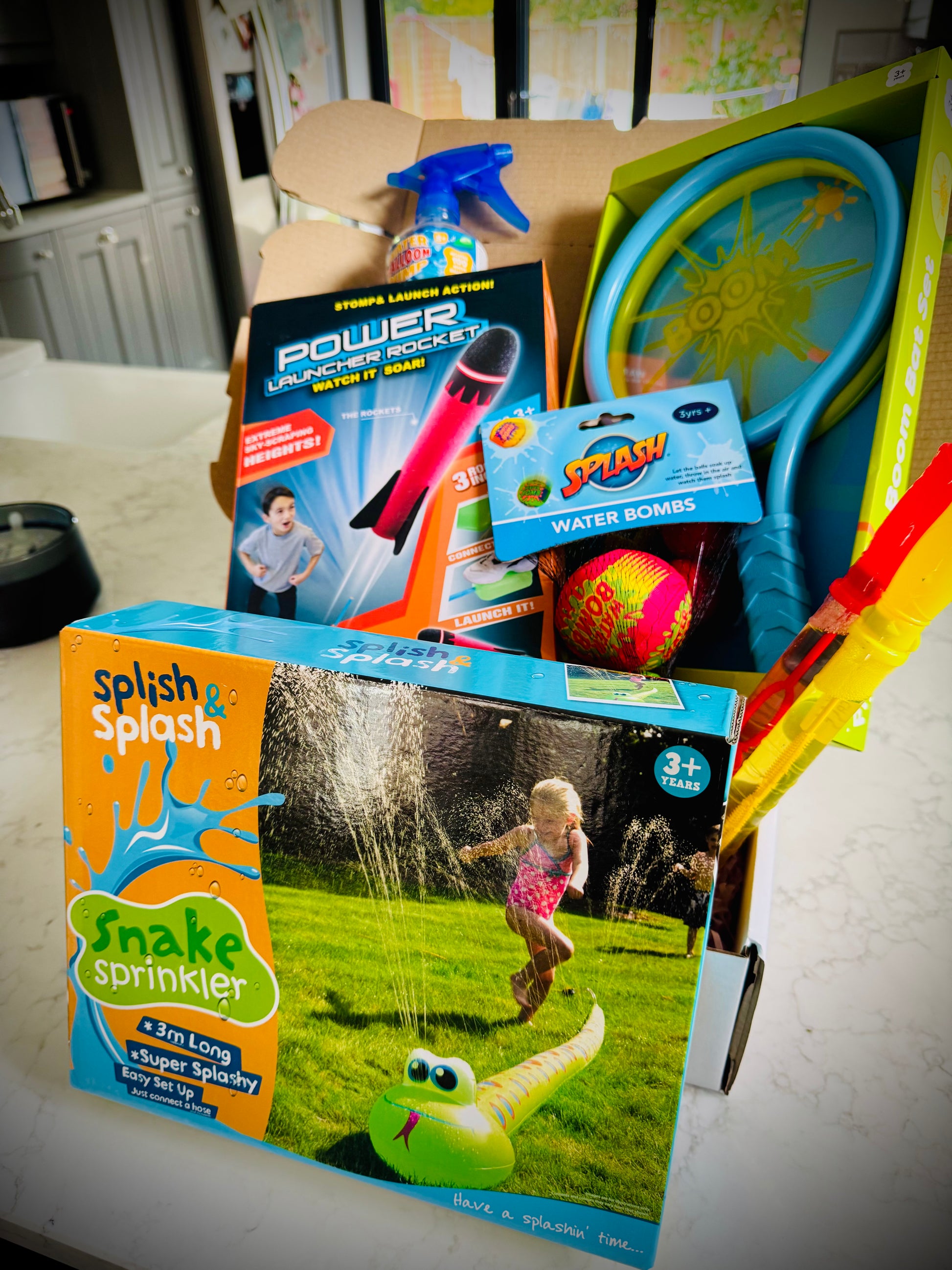 Kids outdoor toys in a birthday gift box with a handwritten card £50