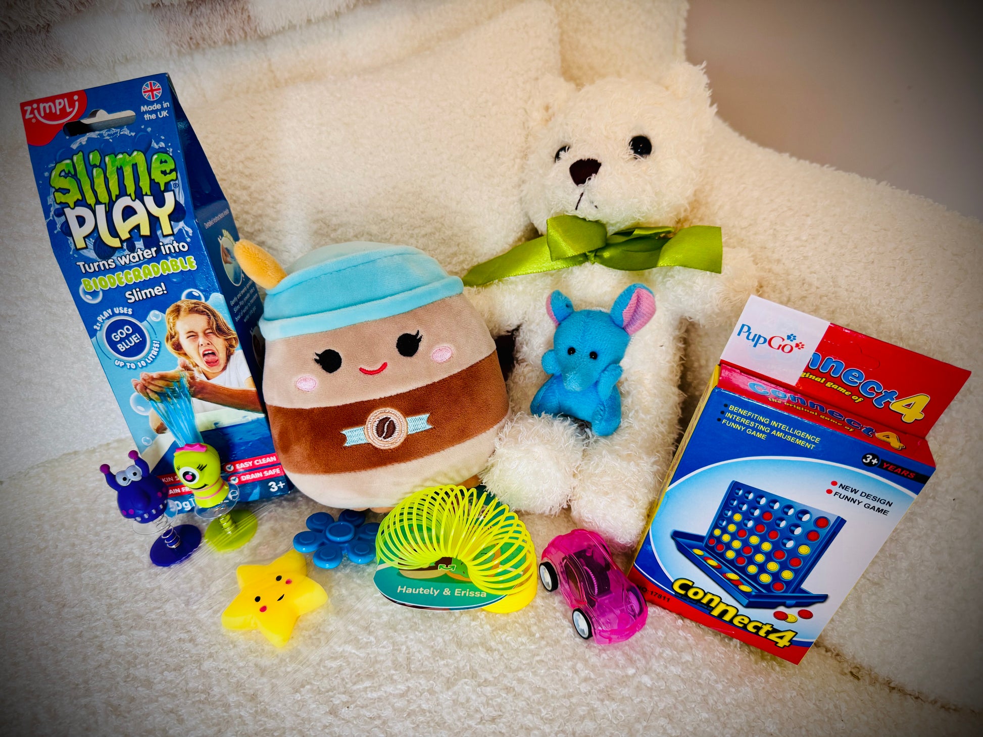 A selection of kids toys in a gift box with a handwritten card £30