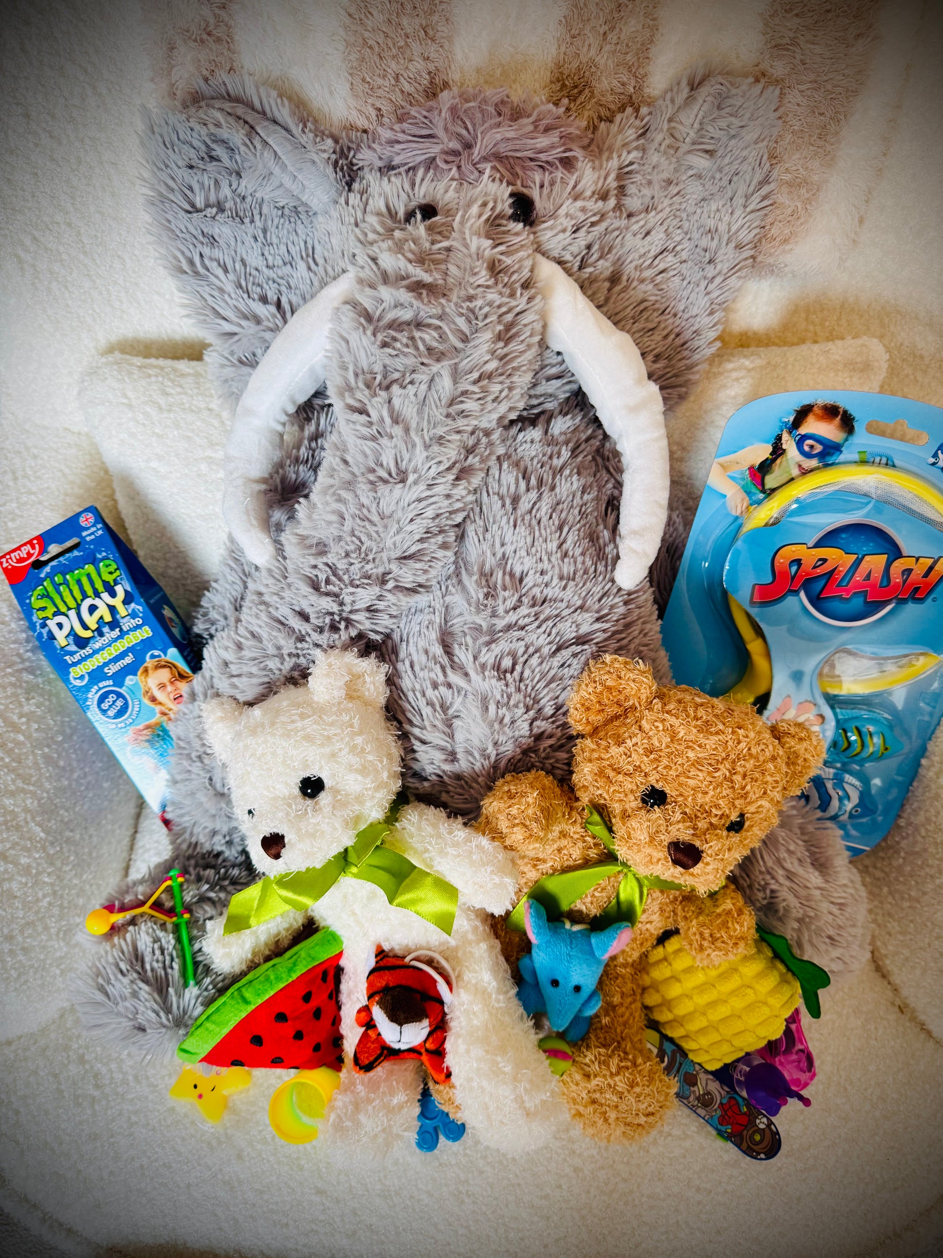 A selection of kids toys in a gift box with a handwritten card £50