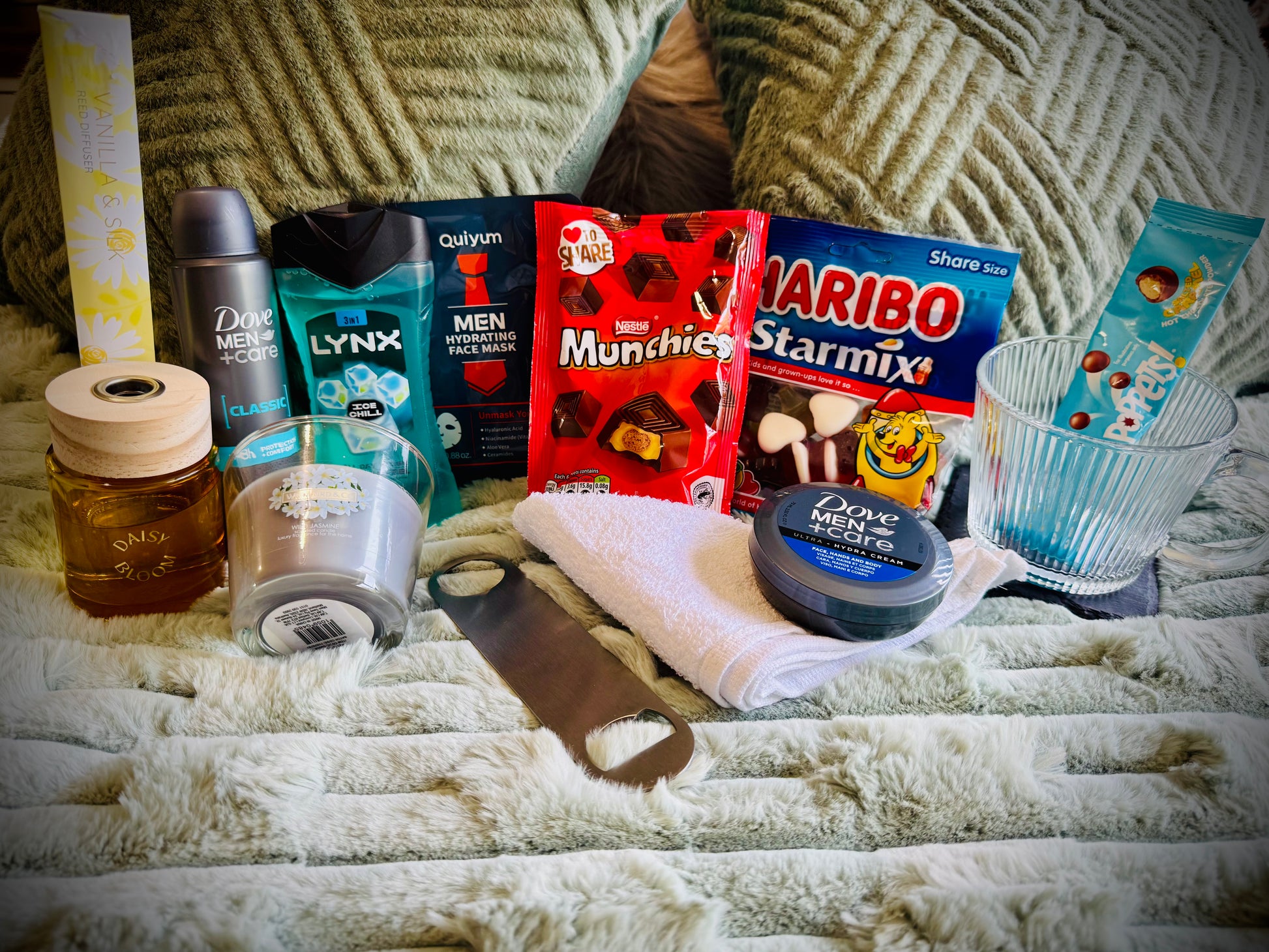 Assorted items including snacks, toiletries, and a candle birthday box with a handwritten card £30