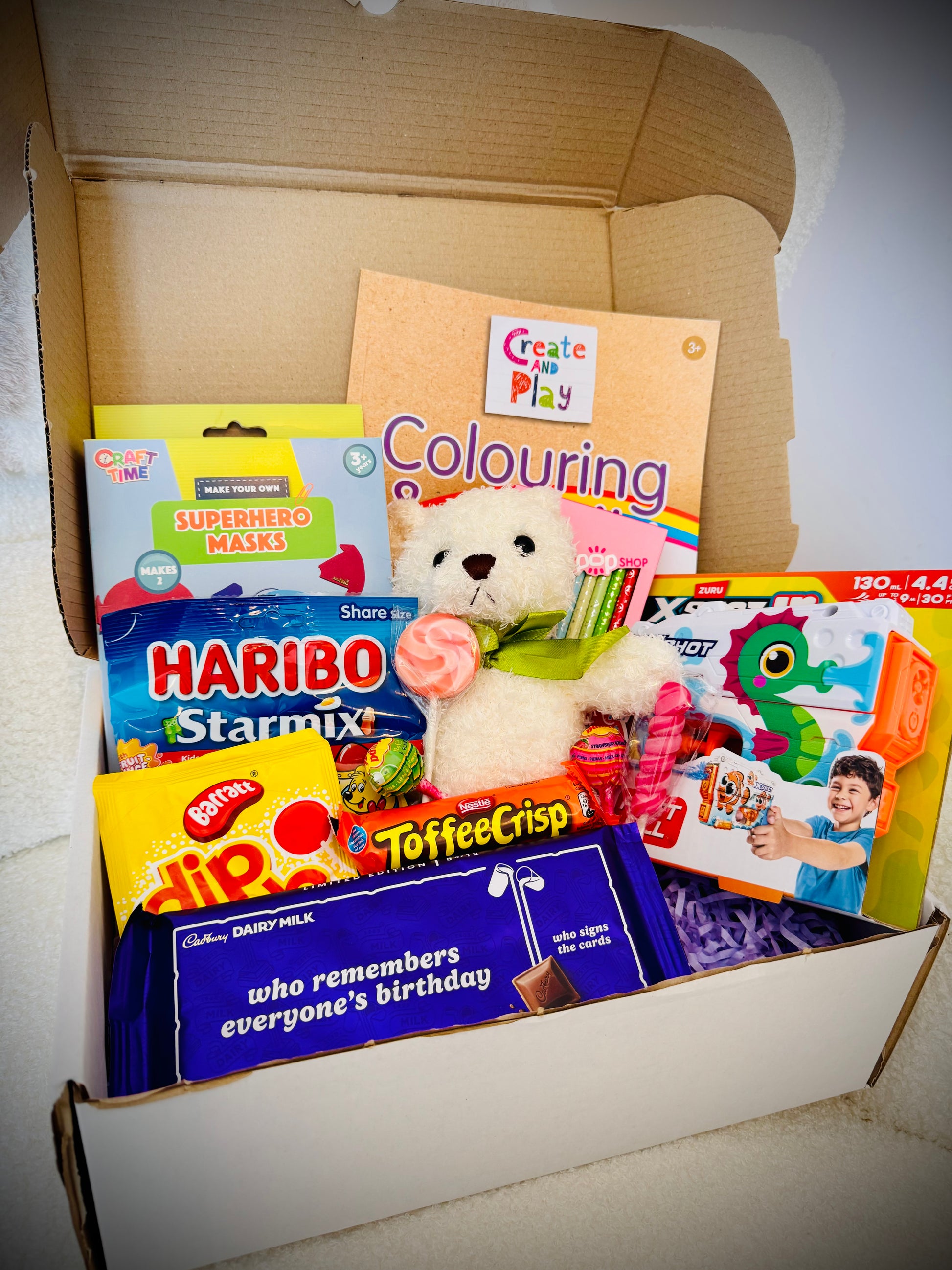Mixed kids birthday gift box with toys art supplies and chocolates £30