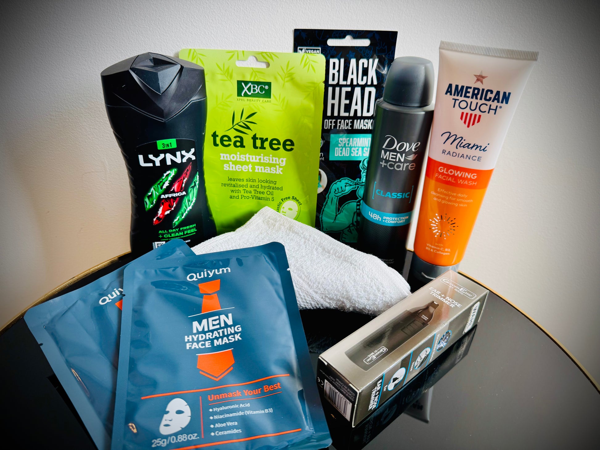Collection of men's grooming products including face masks, soap, and lotion in a gift box with a handwritten card £20