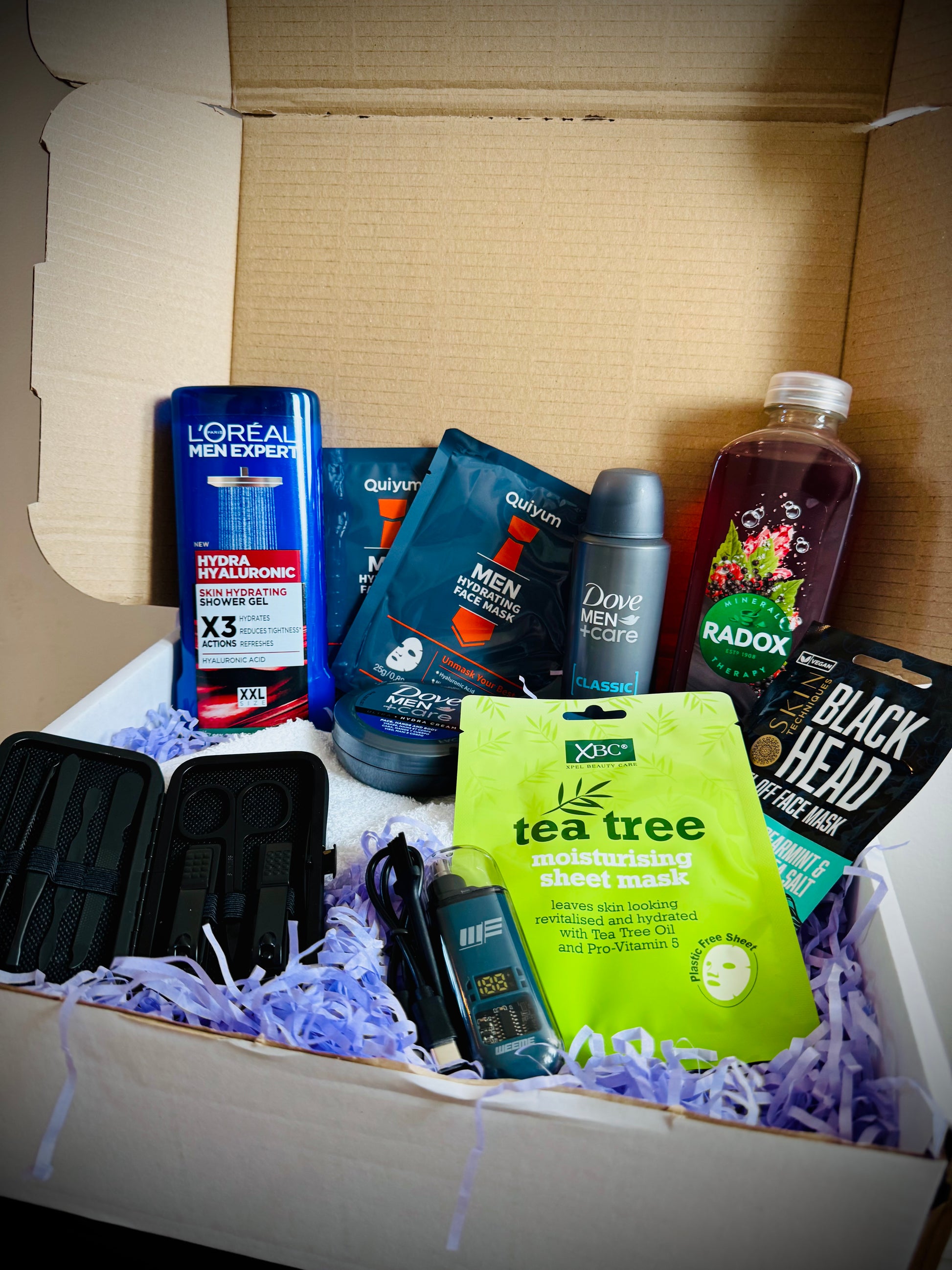 Collection of men's grooming products including face masks, soap, and lotion in a gift box with a handwritten card £30