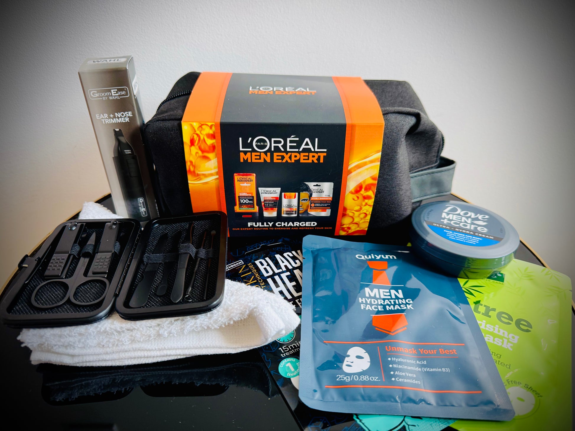 Collection of men's grooming products including face masks, soap, and lotion in a gift box with a handwritten card £50