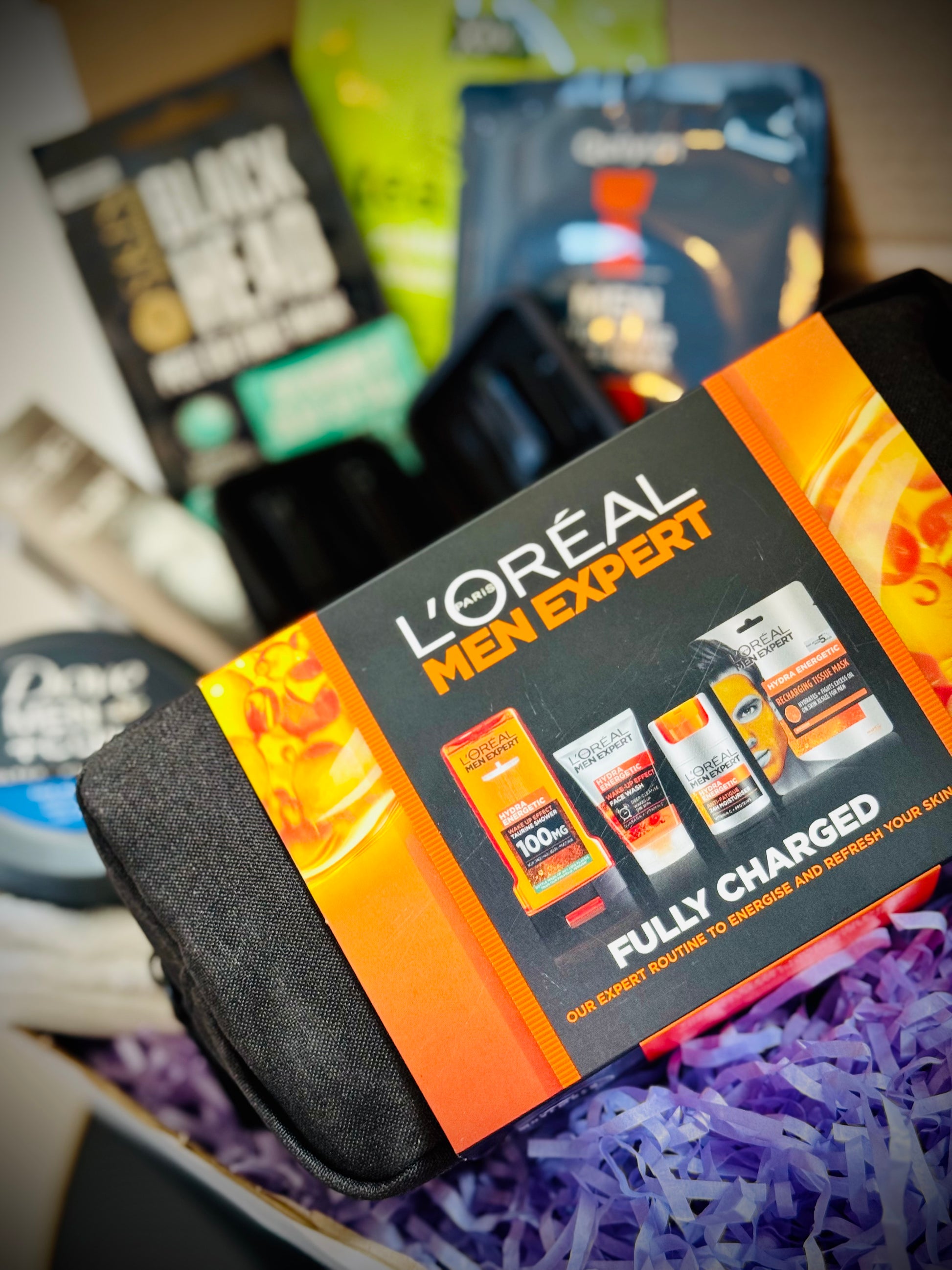 Collection of men's grooming products including face masks, soap, and lotion in a gift box with a handwritten card £50