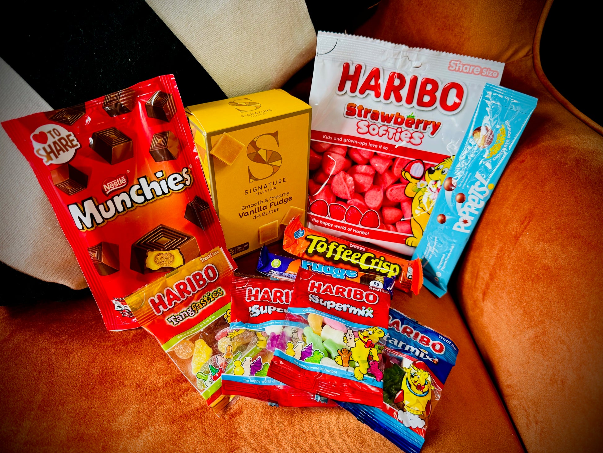 A selection of sweets and chocolates and fudges in a gift box with a handwritten card £10