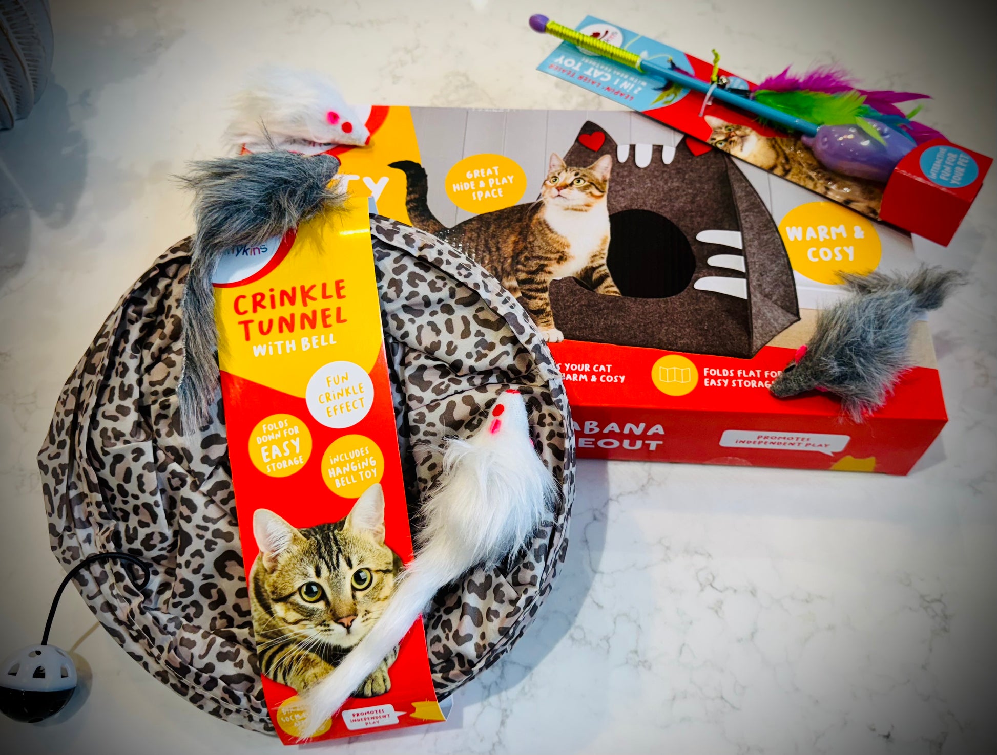 Assorted cat treats and toys with Dreamies packaging in a gift box with a handwritten card £50