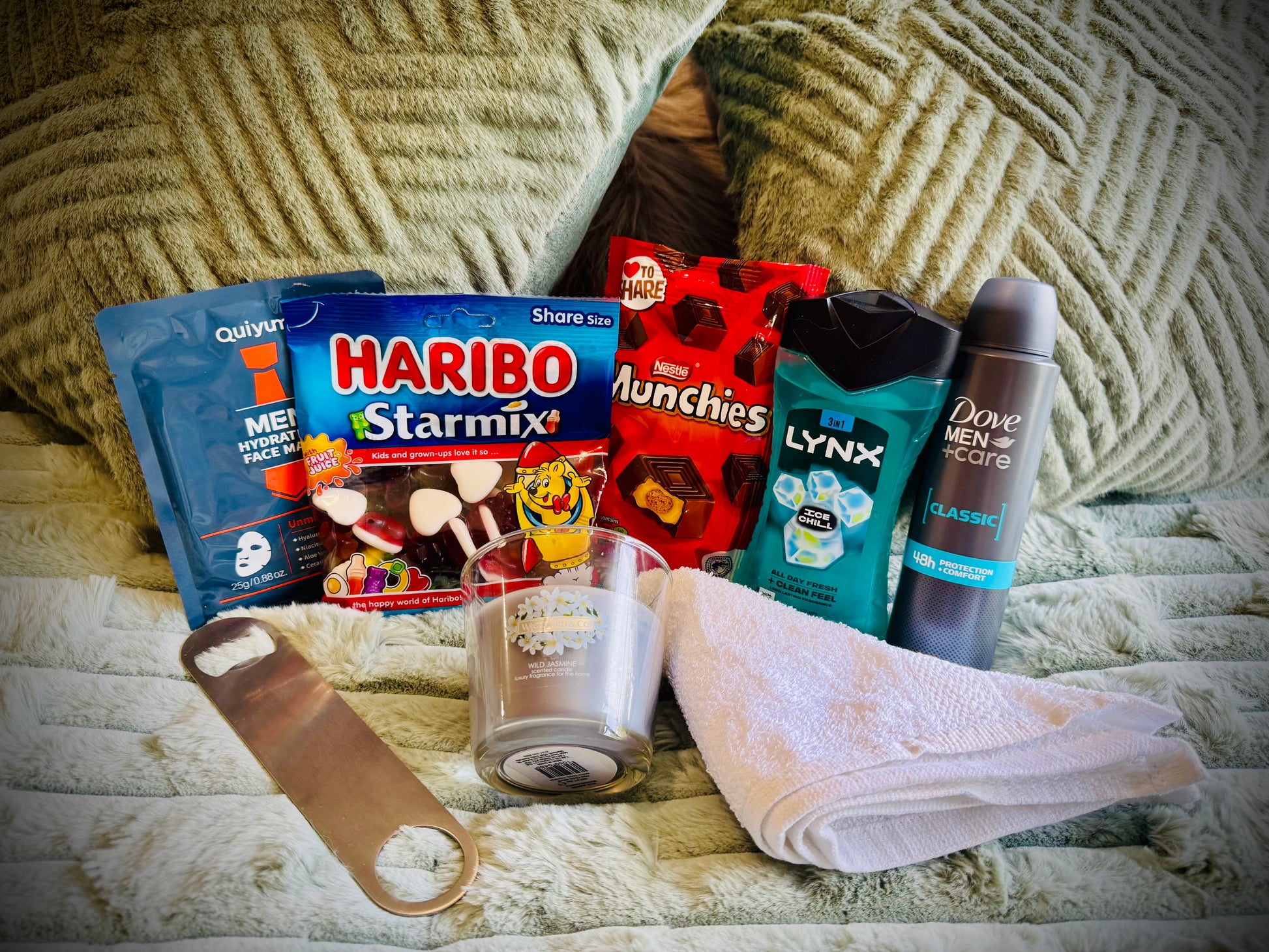 Assorted items including snacks, toiletries, and a candle birthday box with a handwritten card £20