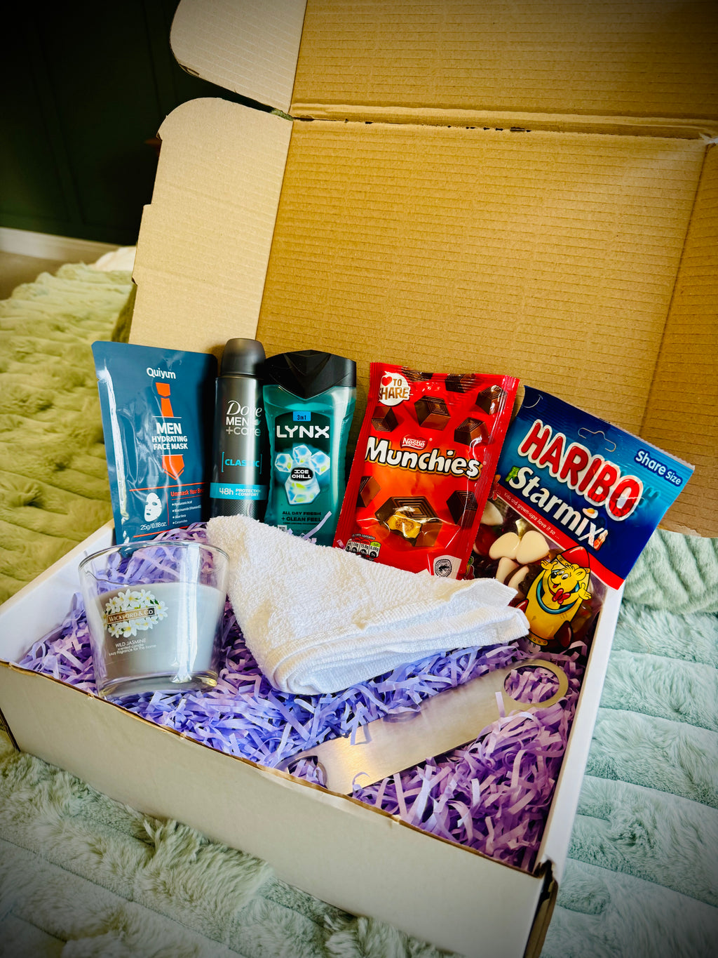 Assorted items including snacks, toiletries, and a candle birthday box with a handwritten card £20