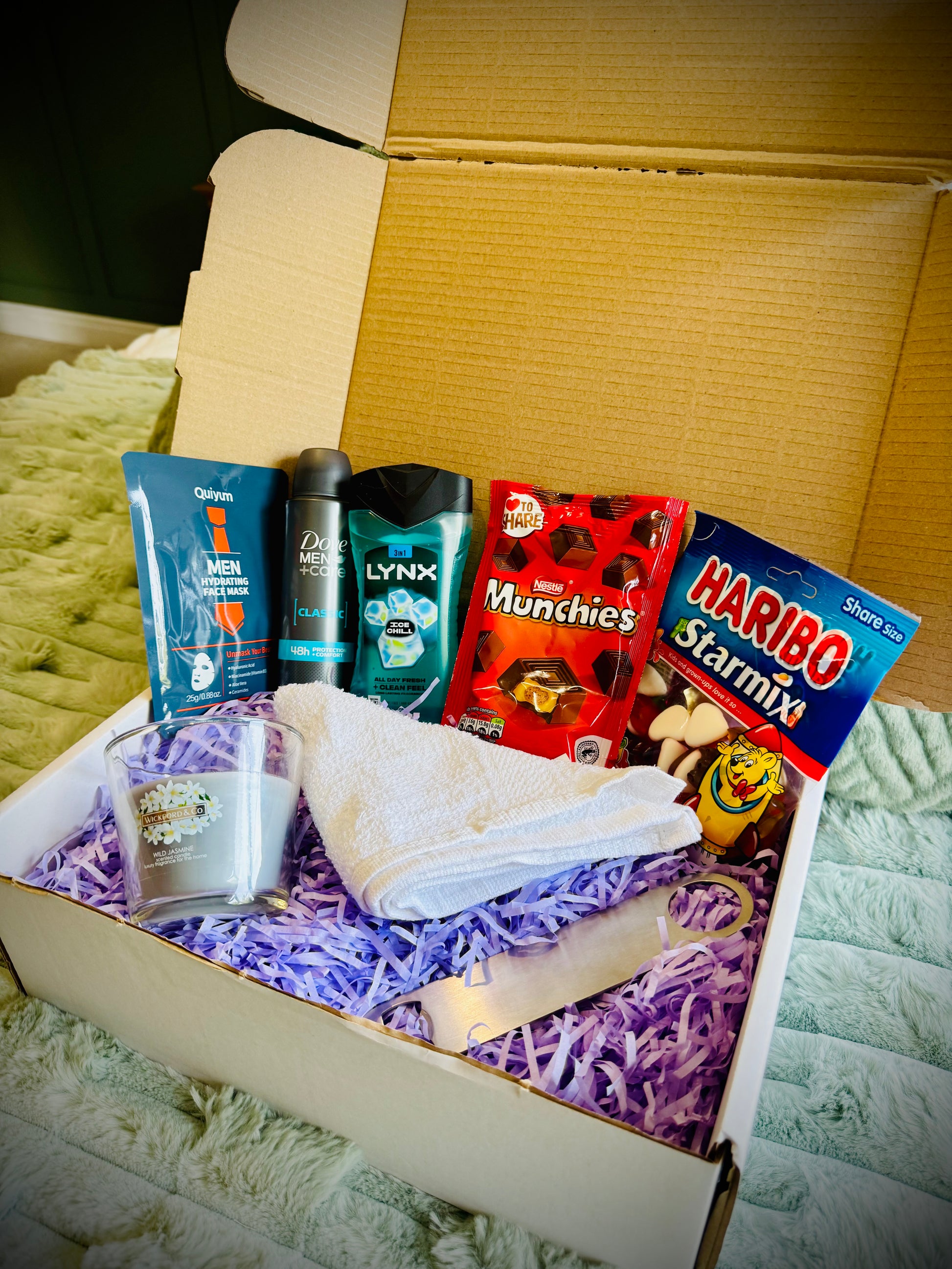 Assorted items including snacks, toiletries, and a candle birthday box with a handwritten card £20