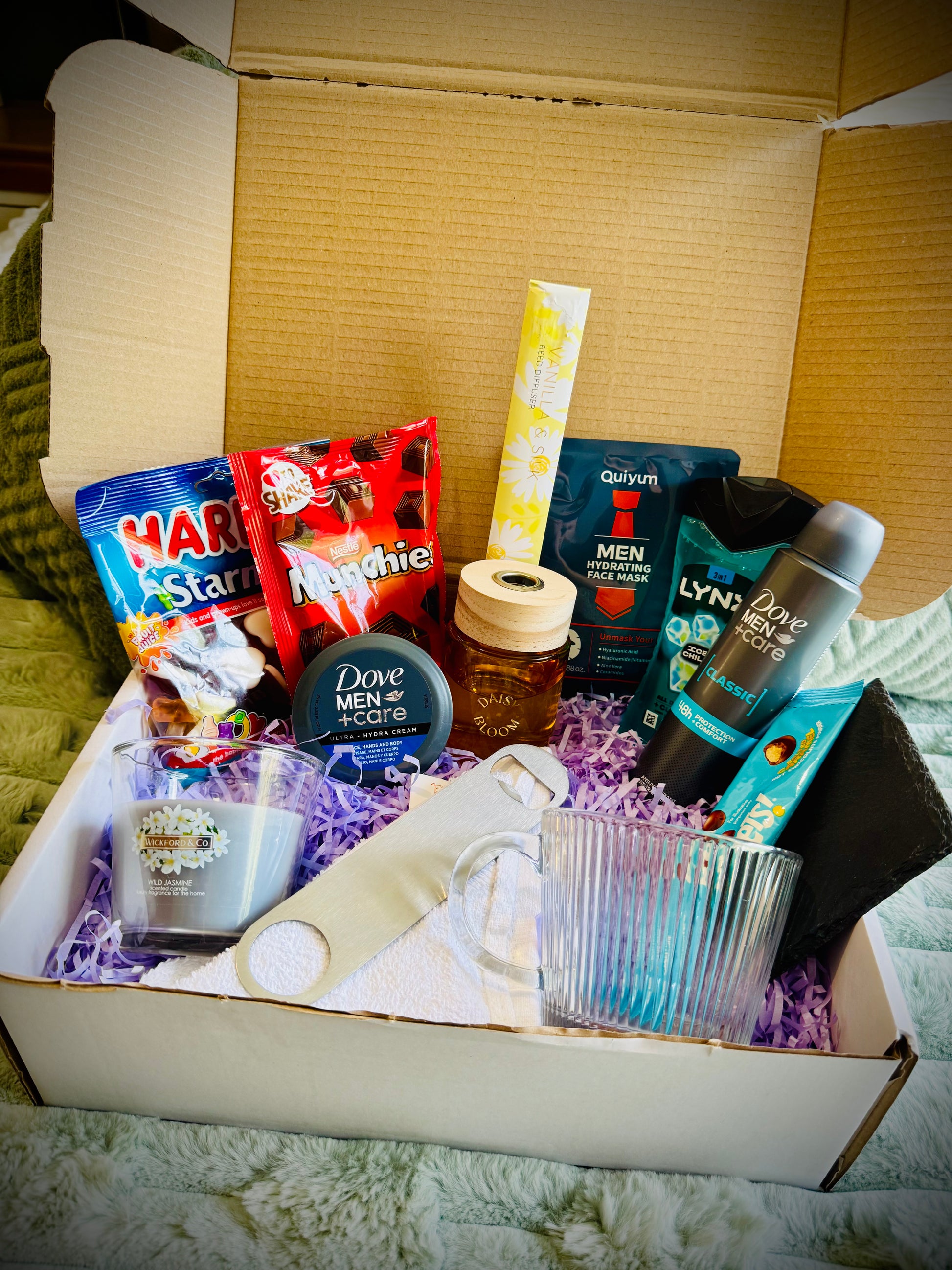 Assorted items including snacks, toiletries, and a candle birthday box with a handwritten card £30