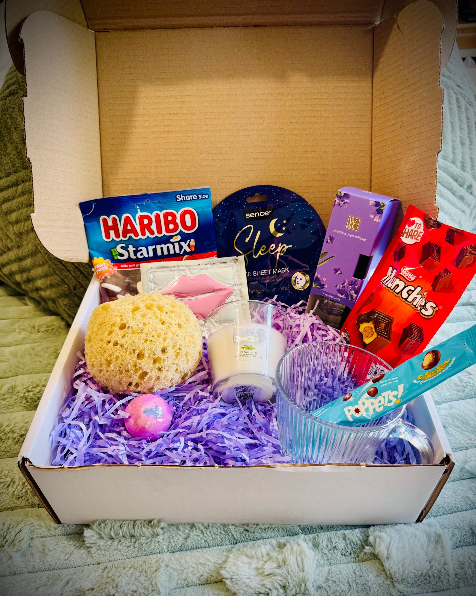 variety gift set for her including sweets and chocolates, skin care and candles with a handwritten card £20