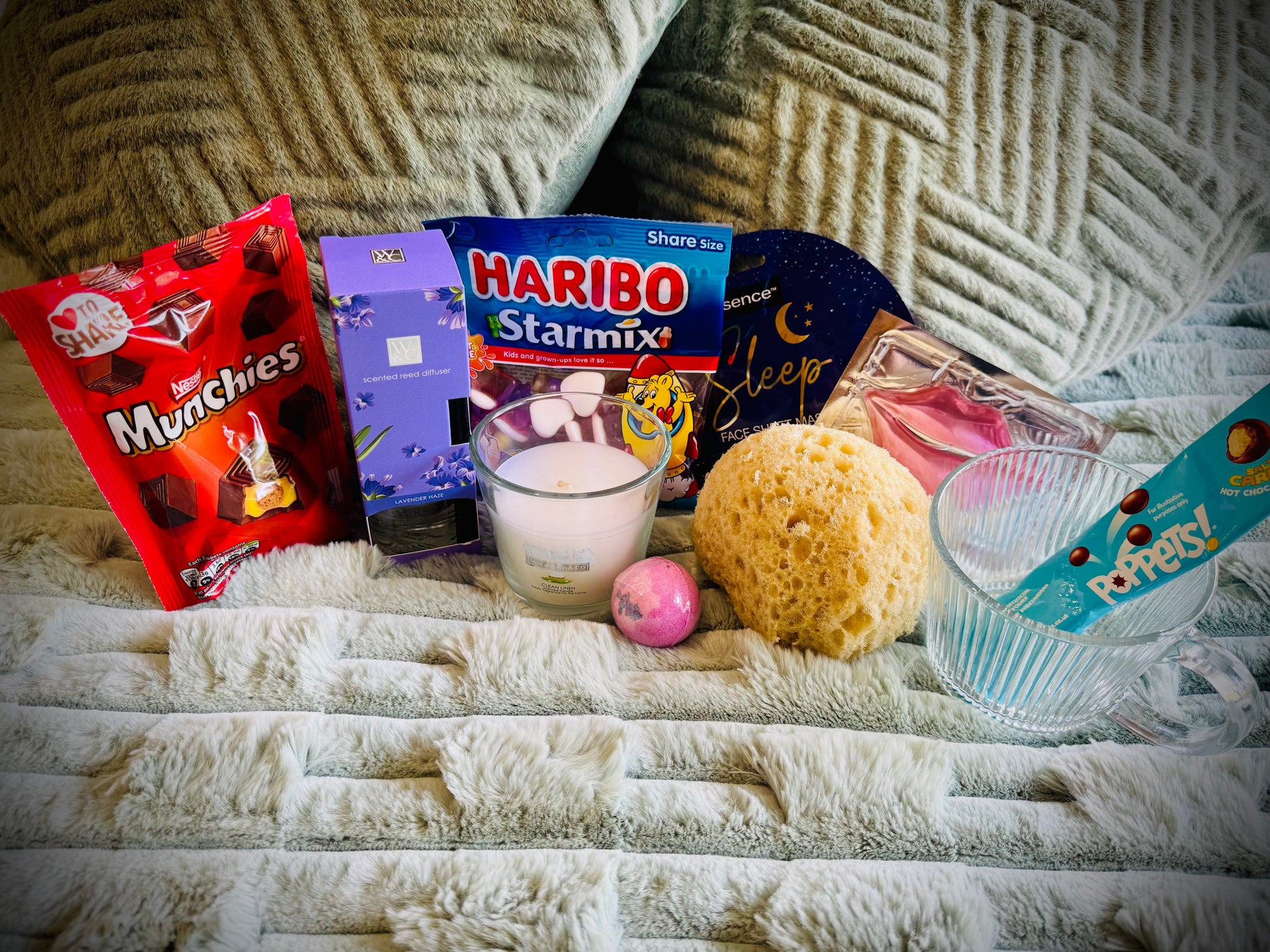 variety gift set for her including sweets and chocolates, skin care and candles with a handwritten card £20