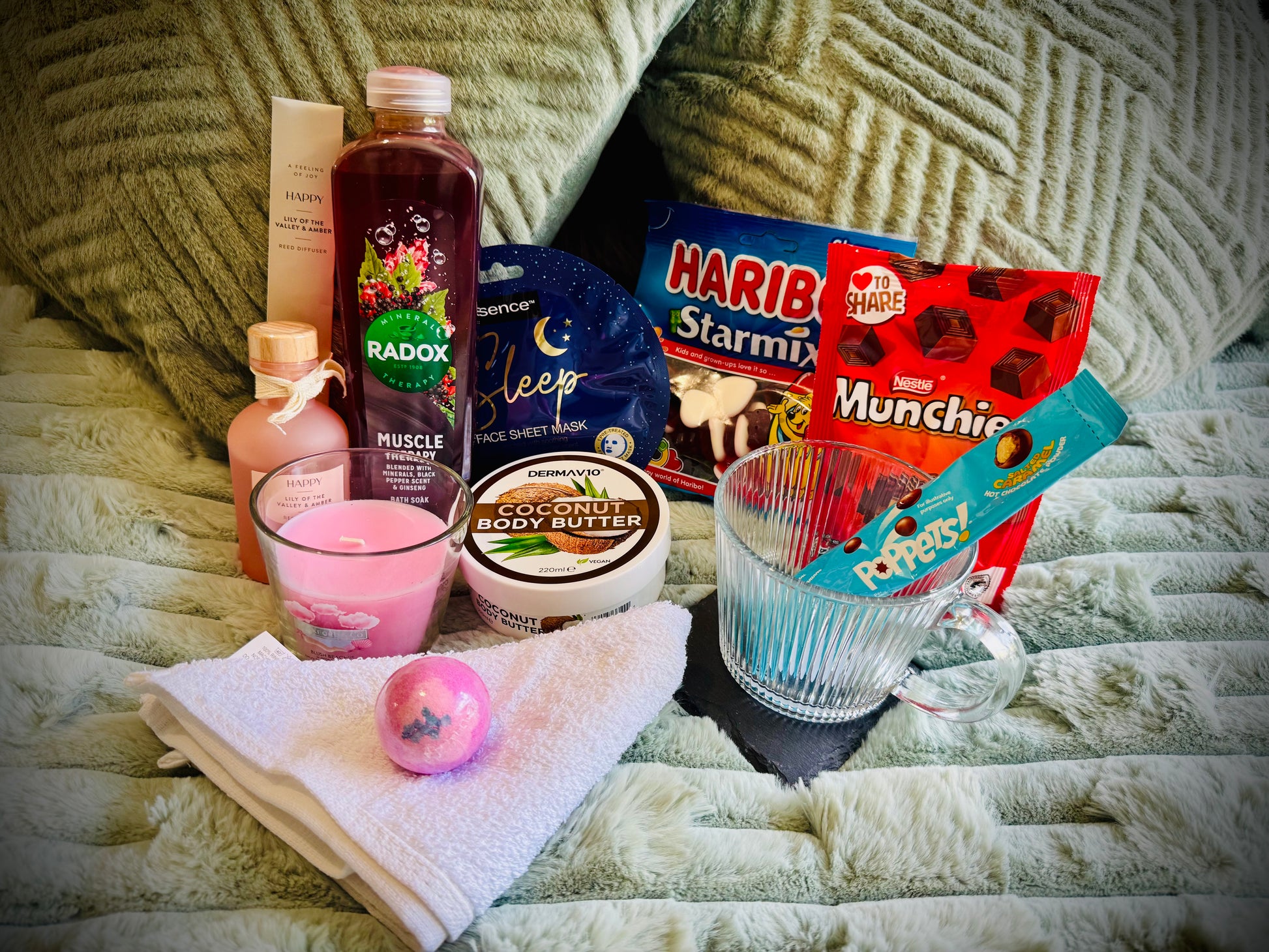 variety gift set for her including sweets and chocolates, skin care and candles with a handwritten card £30