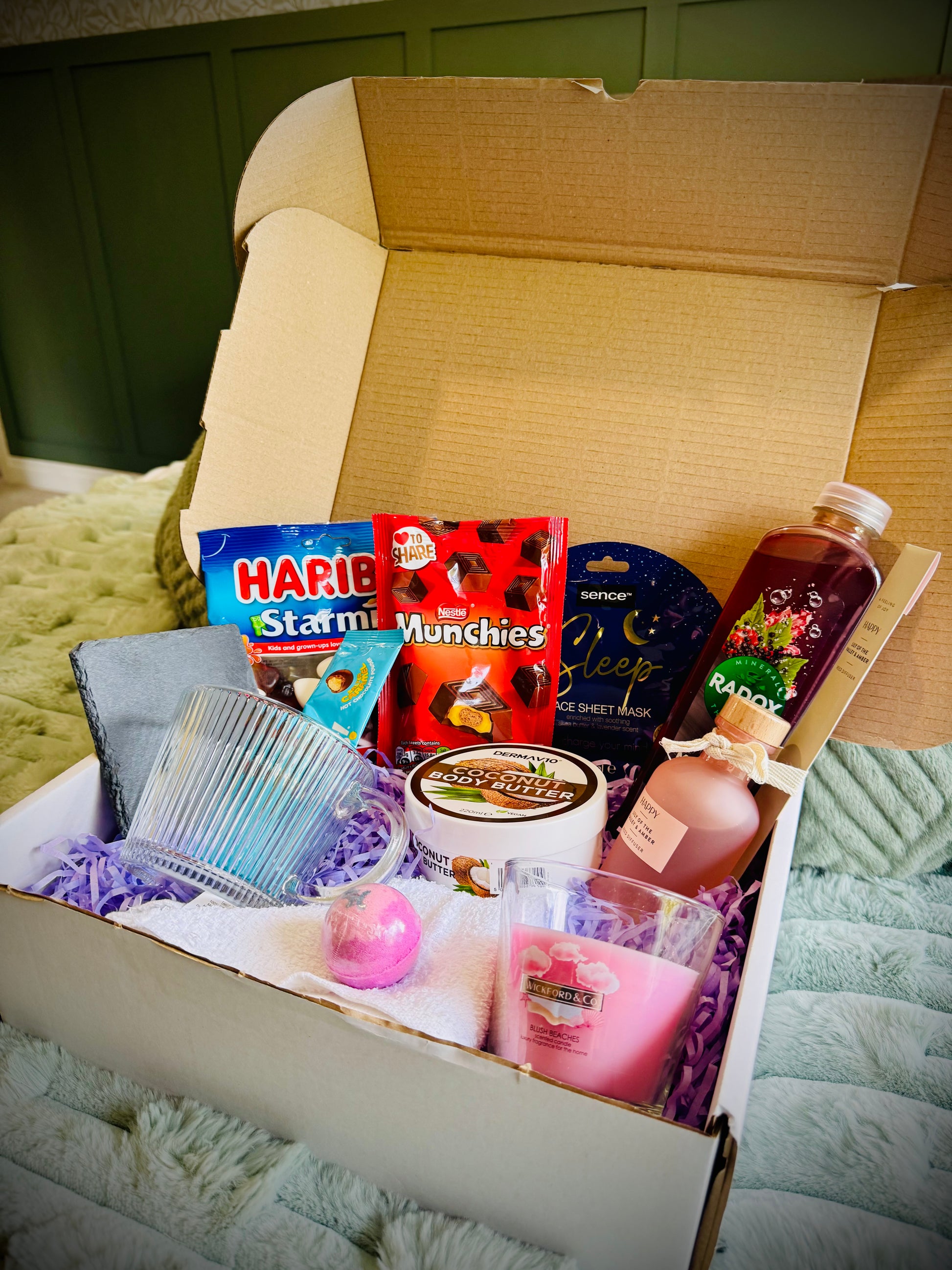 variety gift set for her including sweets and chocolates, skin care and candles with a handwritten card £30
