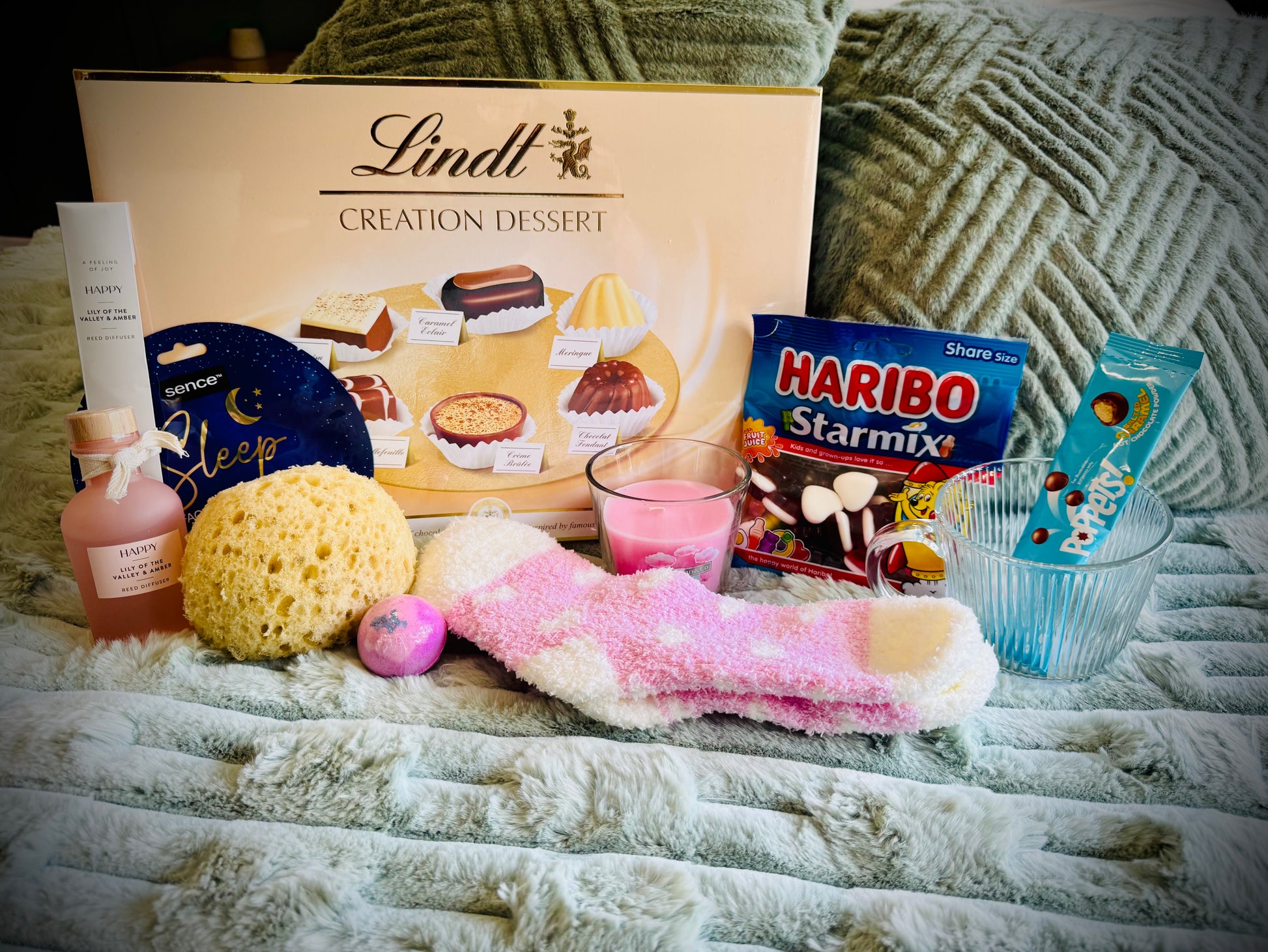 variety gift set for her including sweets and chocolates, skin care and candles with a handwritten card £50