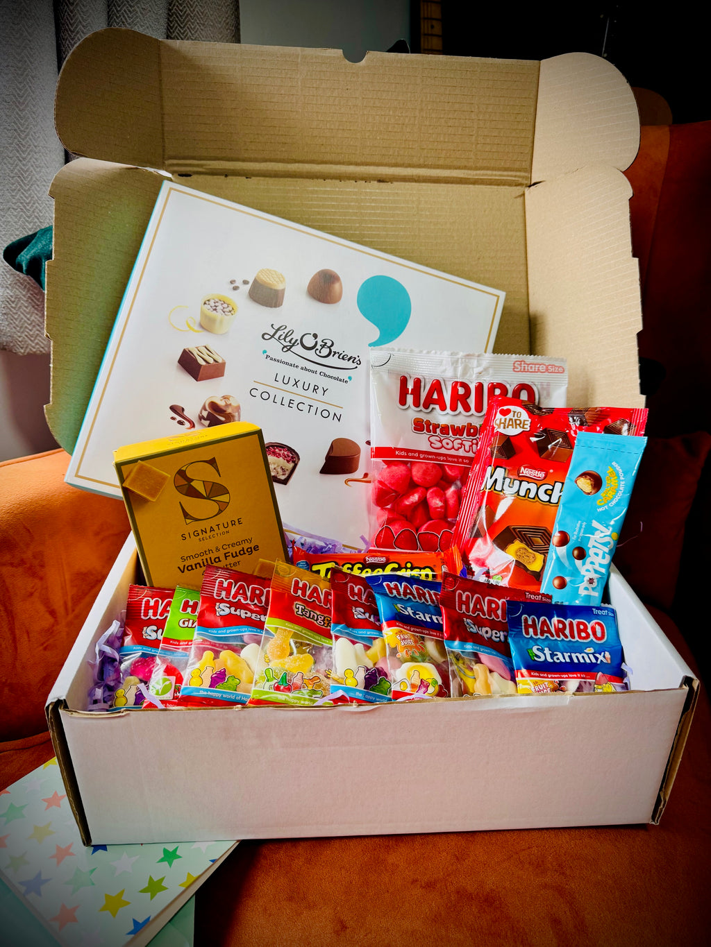 A selection of sweets and chocolates and fudges in a gift box with a handwritten card £30