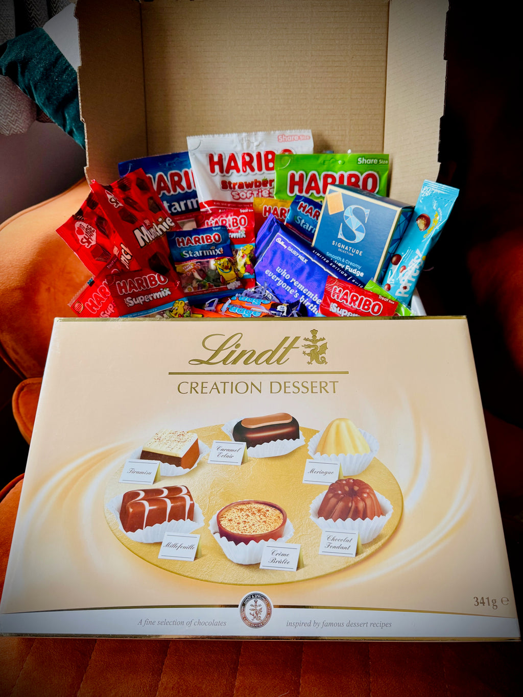 A selection of sweets and chocolates and fudges in a gift box with a handwritten card £50