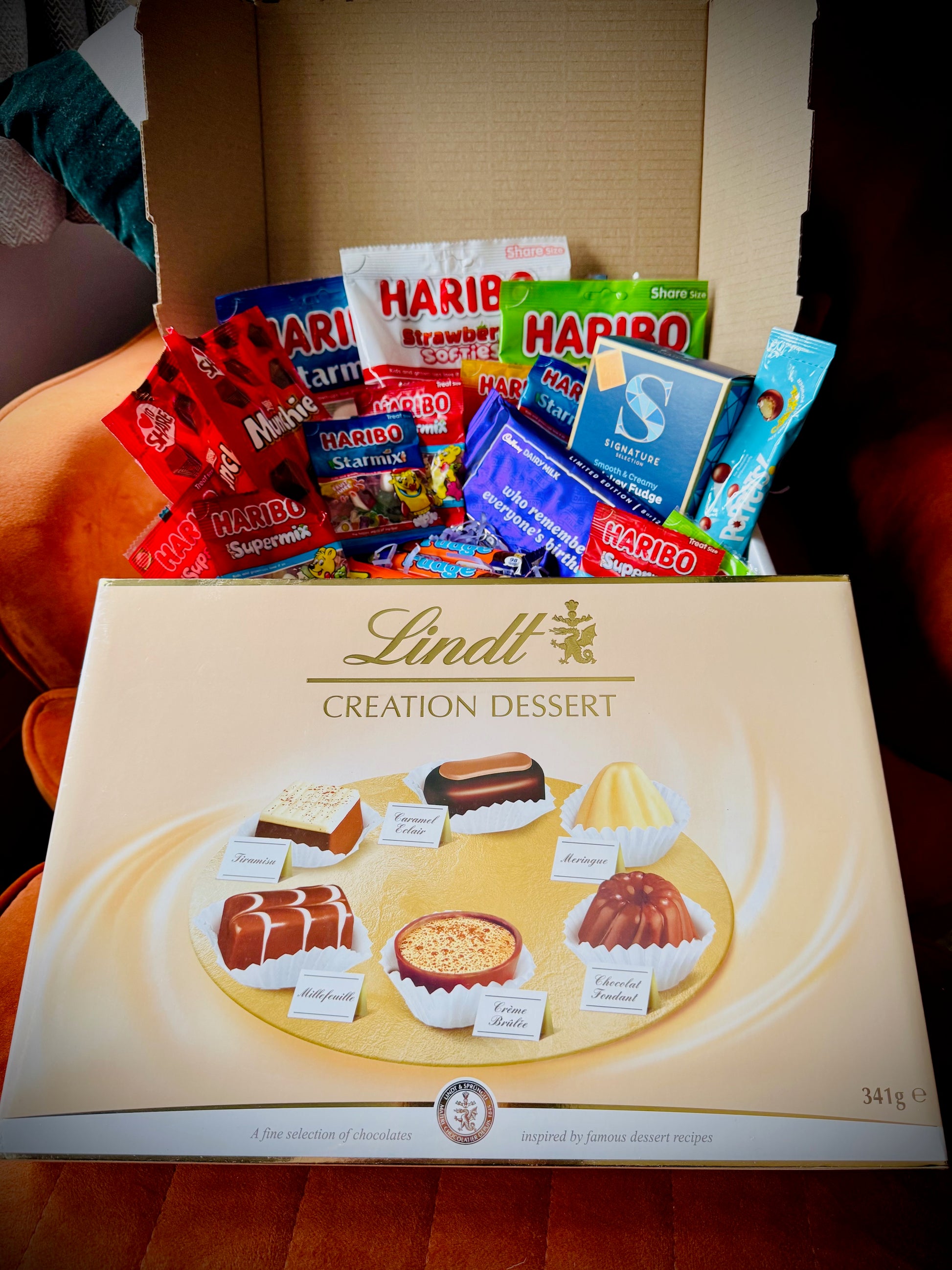 A selection of sweets and chocolates and fudges in a gift box with a handwritten card £50