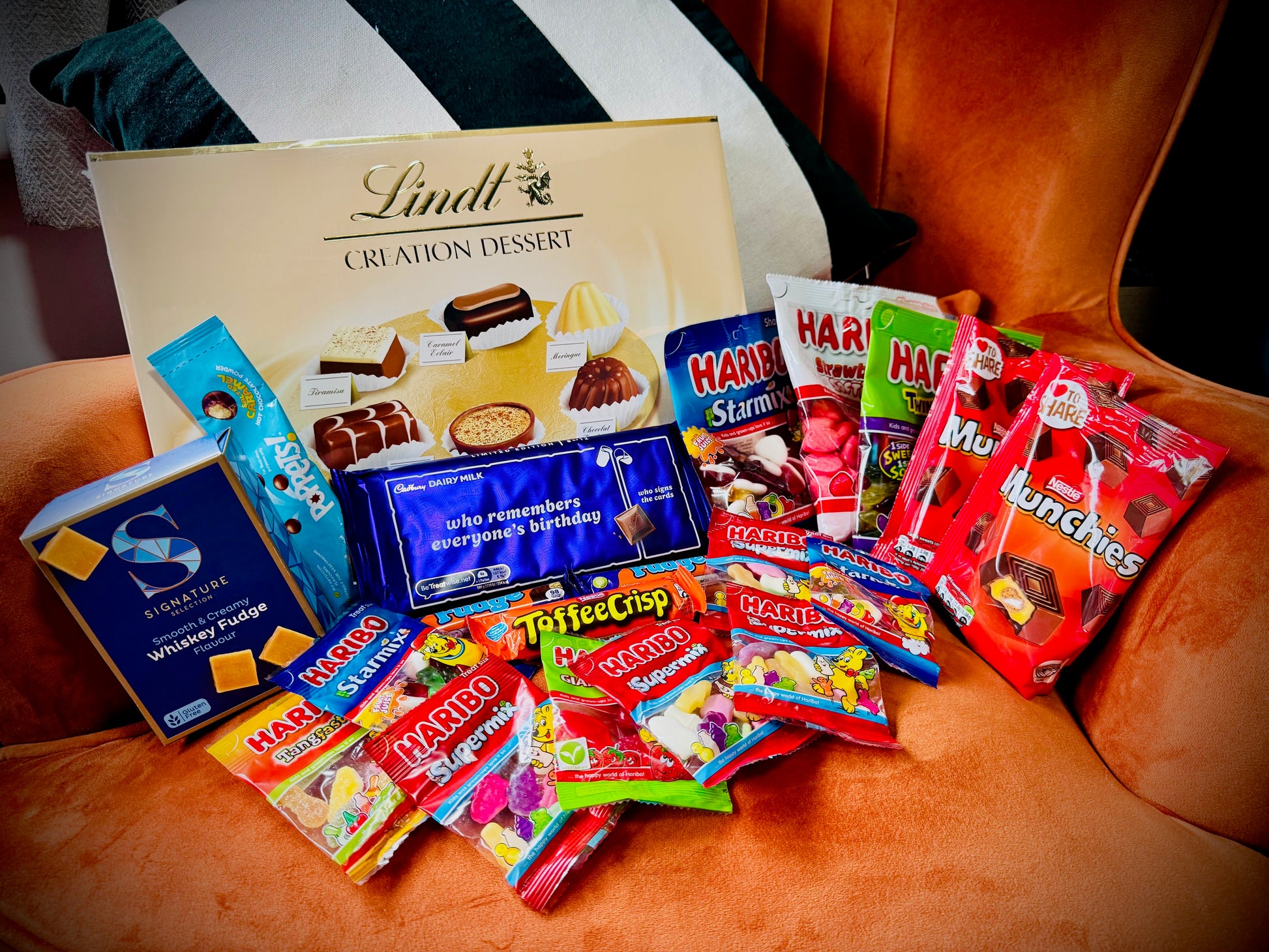 A selection of sweets and chocolates and fudges in a gift box with a handwritten card £50